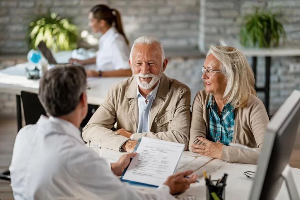 Doctor talking with 2 old patients